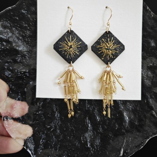 Black gold tassel earrings with firework design