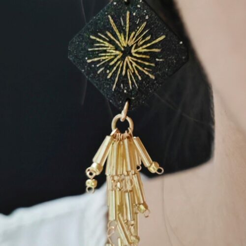 Black gold tassel earrings worn on model